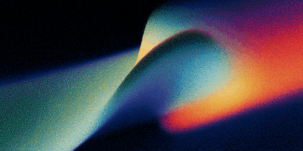 A dynamic, abstract composition featuring a sweeping curve of colour gradients on a dark background. The form resembles a ribbon or wave, transitioning from deep blues and purples on the left to bright oranges, reds, and yellows on the right. The texture is grainy, resembling digital halftone or noise, giving it a tactile, almost print-like quality. The image evokes motion, energy, and transition.