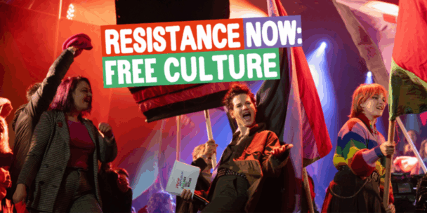 A vibrant stage scene filled with energy and colour. Three young people stand at the forefront waving large red and multicoloured flags, their expressions fierce and joyful. One person raises a clenched fist while another shouts passionately, holding a sign that reads “FREE CULTURE IS NOT A LUXURY – IT’S A RIGHT.” The bold headline over the image says: "RESISTANCE NOW: FREE CULTURE" in large, blocky letters on red, purple, and green backgrounds. The stage is lit with dramatic red and blue lighting, evoking a sense of urgency and movement.