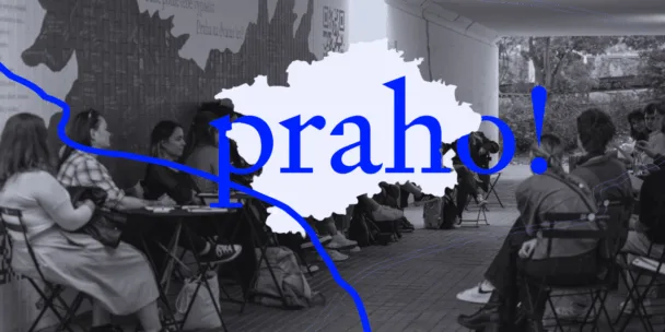 A group of people are sat outside on chairs having a conversation. The photo is in black and white and there is the logo of Praho in the foreground.
