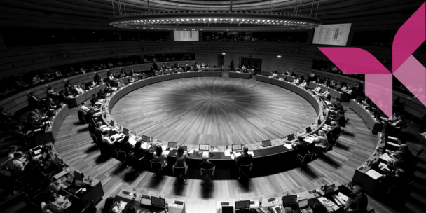 A black and white photo of the meeting room of the Council of the EU with the Culture Action Europe butterfly on top.